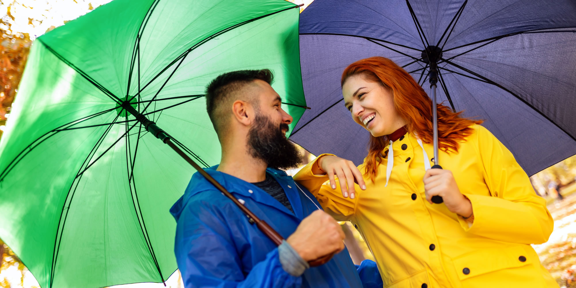 a couple holding umberellas